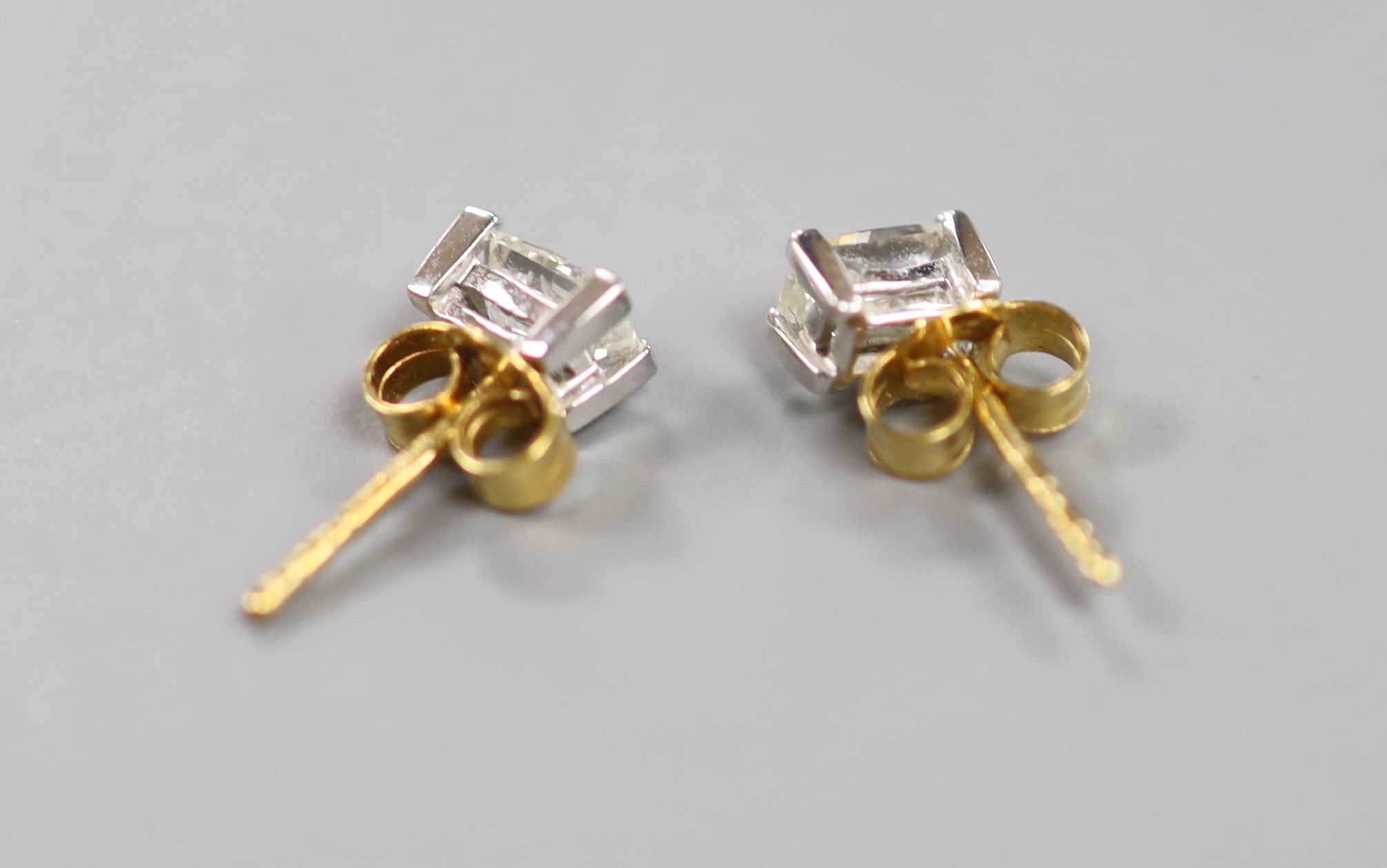 A pair of millennium cut diamond and gold stud earrings.